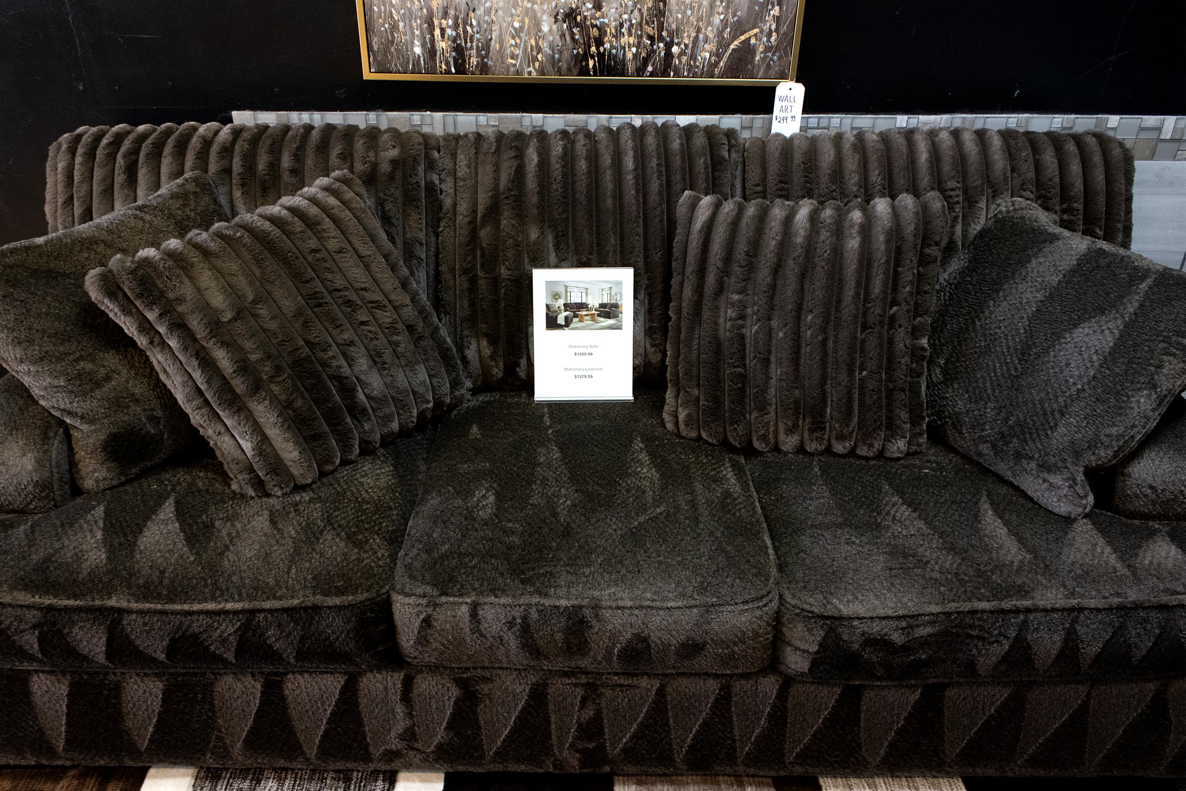 Close detail of sofa and pillows in a JK showroom room package